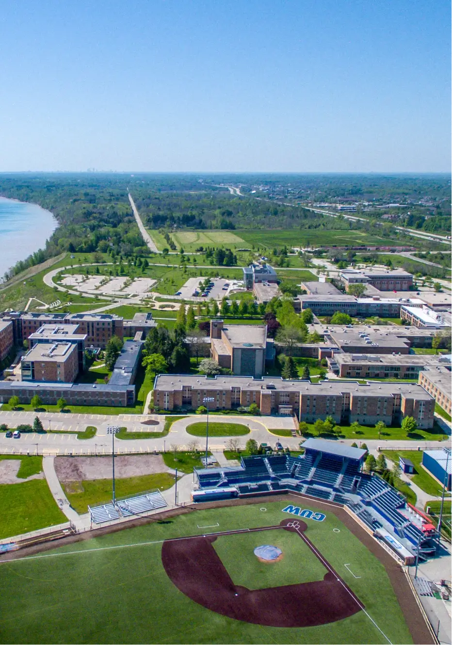 A beautiful view which includes some buildings and grass wit blue sky